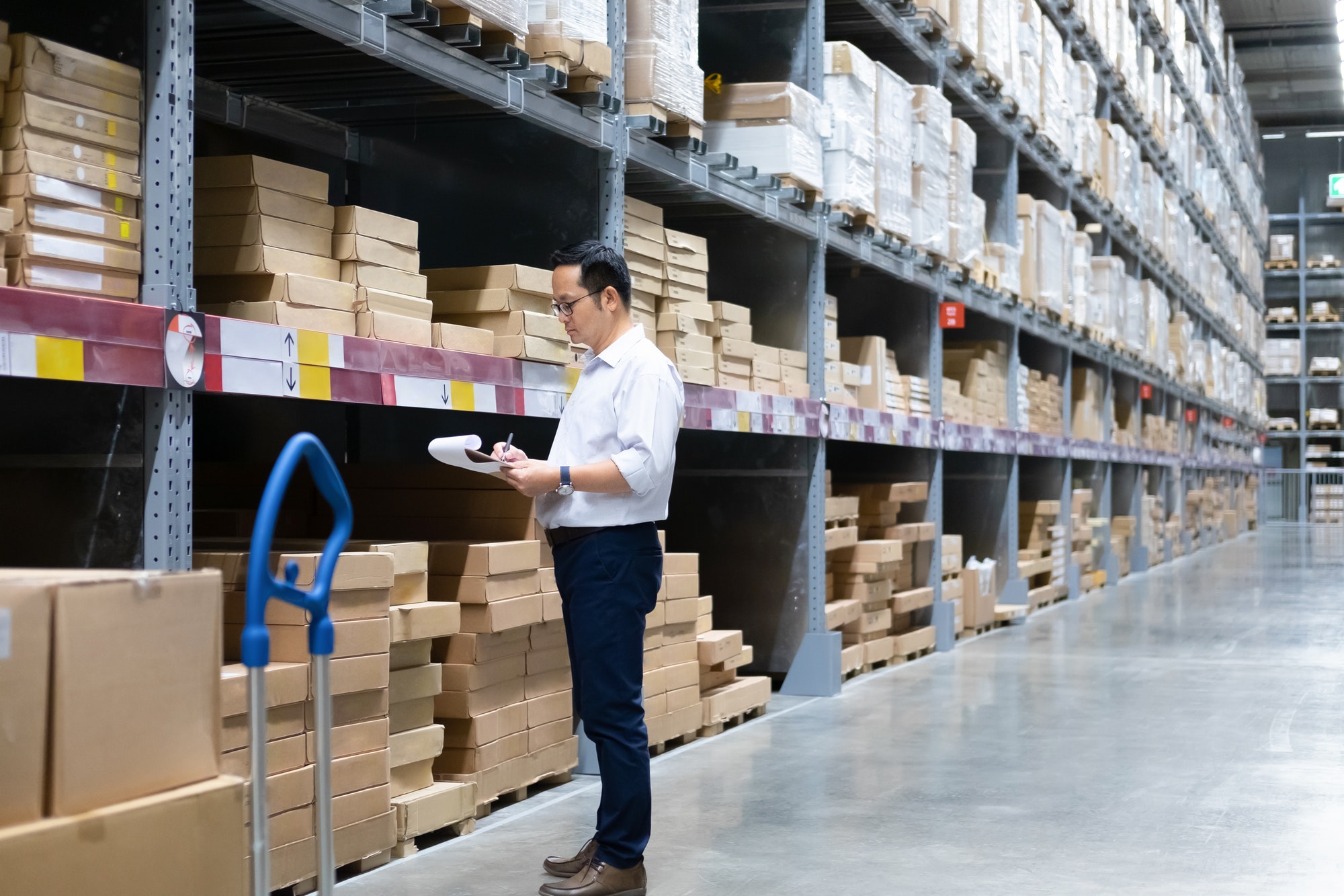 Man warehouse worker checking stock.